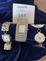 Three fashion watches together showing different strap designs and face styles