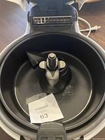 Interior view of the Actifry cooking drum showing the stirring paddle inside the non-stick bowl.