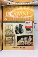 Book titled 'The Fundamentals of Drawing Still Life' showing front cover with drawings and price sticker.
