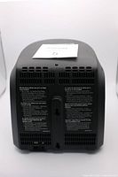 Back view of the transmitter unit showing alarm vents and warning labels.