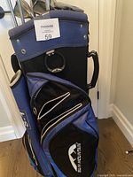 Photo of blue and black Sun Mountain golf bag with multiple compartments, showing its overall shape and condition.