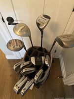 Top view showing multiple golf clubs in bag including driver, woods, irons