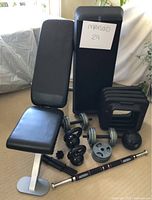 Overall view of bench, weight set components, kettlebells, medicine ball, step surface