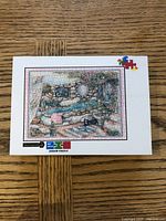 Photo of Cobble Hill bath scene jigsaw puzzle box showing a completed puzzle image of a bath setting with various items and decor.