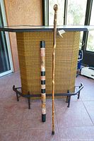 Photo showing both didgeridoo and hiking staff side-by-side indoors for scale comparison.