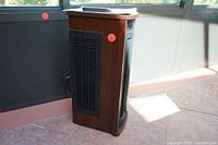 Side view showing wooden panel and air vent grille of Duraflame Twin Star electric heater