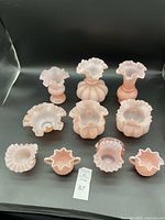 Ten-piece grouping on black background showing all items in lot