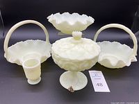 Full set of the vintage Fenton custard satin glass items showing all six pieces, including baskets, candy dishes, and toothpick holder, against a black backdrop