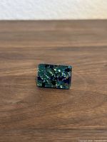 Front view of vintage Murano Italy glass ring with multicolored blue-green flecks in rectangular glass top.