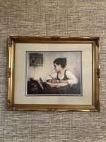 Framed print hanging on textured wall, showing the full print and gold decorative frame