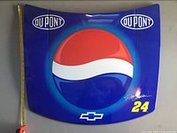 Front view of blue metal hood with large Pepsi logo, DuPont logos, Chevrolet emblem, Jeff Gordon signature, and number 24