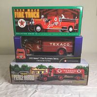 Front view of all three boxed Texaco trucks stacked, visible model names and packaging details.