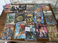 15 vintage comic books including X-Men, Wolverine, and other titles spread on a wooden surface.