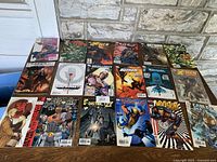 Full display of 18 comic books with diverse titles arranged on stone surface