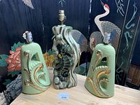 Overview of three vintage lamps: two green ceramic with gold accent lamps and one ceramic seahorse sculpture lamp