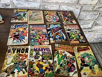 Full set of 12 Marvel vintage comics displayed on stone background showing varied Marvel heroes