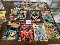 Photo showing 12 vintage comics from Marvel and DC including Spider-Man, Star Wars, Aquaman, Isis, Wonder Woman, and others