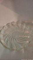 Top view of Mikasa Peppermint clear glass platter showing swirling peppermint pattern and scalloped edges.