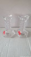 Pair of Towle full lead crystal candlestick holders with original Towle labels visible, one showing spiral stem pattern and hexagonal base