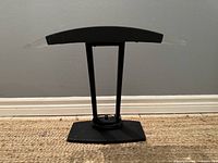Front view of the black rectangular base and lamp upright supports