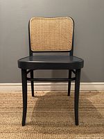 Front view of chair showing seat and cane backrest