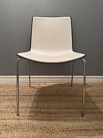 Front view of white Pedrali Tweet 890 chair showing polypropylene seat and backrest with chrome legs