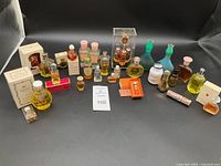 Photo showing full lot of various vintage perfume and fragrance bottles, some boxed, others loose. Includes a variety of sizes and styles.