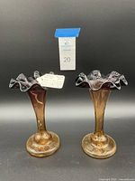 Front view of both Amberine Jack In The Pulpit glass vases side by side showing the amber-to-black gradient and crimped edges, labeled with lot number.