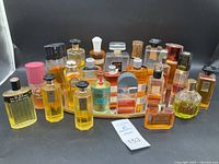 Wide frontal view showing all perfume bottles arranged on the mirrored tray with a label in front.