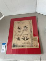 Framed patent blueprint featuring two views of Raggedy Ann doll in front and side profile with signatures and patent info