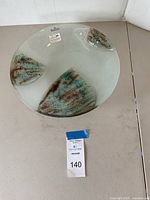 Top and side view of Rosenthal centerpiece bowl with three turquoise and brown abstract accents on a gray base.