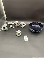Full view of the 4 Tiffany & Co. floral cups, Occupied Japan cup and saucer, and Royal Stanley Ware stoneware bowl.