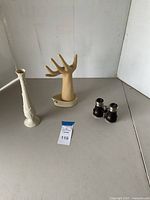 Lot overview showing white Lenox vase, vintage jewelry display hand, and vintage binoculars.