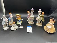 Overview showing 7 Josef vintage figurines and 2 Lenwile perfume bottles with stoppers on display