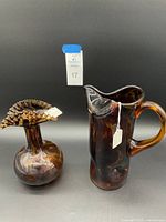 Photo showing both tortoise glass items together on black background for scale and comparison.