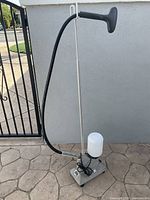 Full view of Jiffy professional clothes steamer showing base unit, water tank, pole and hose with handle.