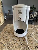 Front view of white Krups coffee maker with water level indicators and control dial