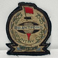 Front view of the embroidered Brantford Country Club patch showing detailed gold and silver threadwork with red flag and golf ball.