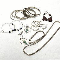 Full view of the collection showing bangles, earrings, bracelets, and necklaces arranged on white background