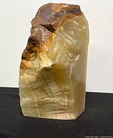 Front and side view of solid calcite stone pillar showing its polished and natural rough textures.