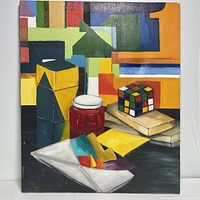 Front view of the oil painting showing vibrant color blocks, still life objects including Rubik's Cube, jar, and papers.