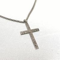 Close-up of the sterling silver cross pendant showing ironstone crystals and details including some missing crystals and the stamped sterling on the back.