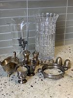 Full lot showing Czech crystal vase, glass vase with pewter floral accent, and various silver-plated serving ware pieces including Lion's Head Viner of Sheffield toothpick holders, creamer, shakers, small candle cup and pierced tray.