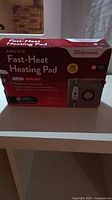 Front view of boxed King Size Fast-Heat Heating Pad from Walgreens showing brand, model, and features on packaging.