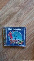 Front cover of No Doubt Tragic Kingdom CD album featuring artwork with a woman in red and text.