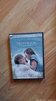 Front cover of The Notebook DVD showing the movie's cover image featuring a man and a young girl embracing.