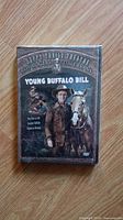 Front cover of the Young Buffalo Bill DVD showing main character with horse, in Western style design.