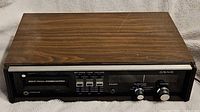 Front view of Craig 8 Track Player showing wood grain top and black front panel with tone and volume controls.