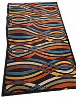 Full view of the large outdoor rug displaying the abstract wave pattern and its size.