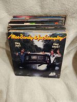 Stack of vintage vinyl records with Moe Bandy & Joe Stampley 'Hey Joe! Hey Moe!' album visible on top